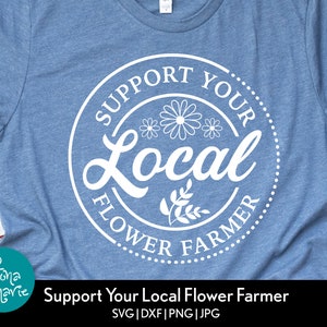 May include: A blue t-shirt with a white circle design that says "Support Your Local Flower Farmer" with stylized flowers and leaves.