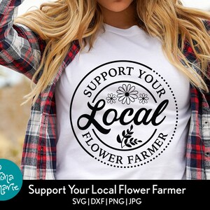 May include: A white t-shirt with a black circle design that says "Support Your Local Flower Farmer" with a stylized flower graphic.