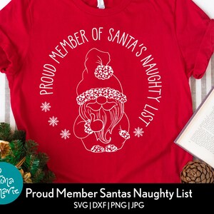 May include: Red t-shirt with a white design of a gnome with a beard and the text "Proud Member of Santa's Naughty List".