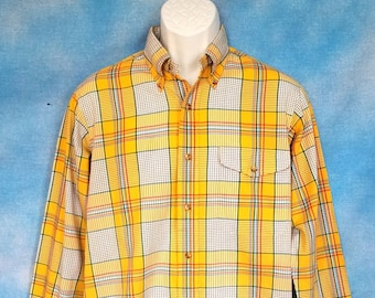 May include: A yellow, white, red, and blue plaid long-sleeve button-up shirt.