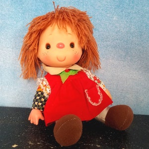 Vintage 70s Small Cloth Bodied Smiling Doll with Plastic Head, Auburn Yarn Hair, Pink Nose, Calico Arms, Brown Shoes, Red Dress/ 7.5” height