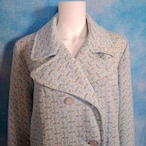 May include: A long-sleeved, double-breasted coat with a geometric pattern in shades of blue and gray.