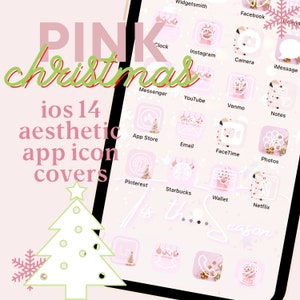 May include: A pink and white iPhone screen with a Christmas theme. The icons are all white with a pink outline and have a Christmas-themed design. The text "It's the season" is written in white on a pink background.