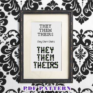 May include: A black and white cross-stitch pattern with the words "THEY THEM THEIRS" in green and black. The pattern is framed in a black frame and is displayed against a black and white patterned background. The words "PDF PATTERN" are printed in purple at the bottom of the image.