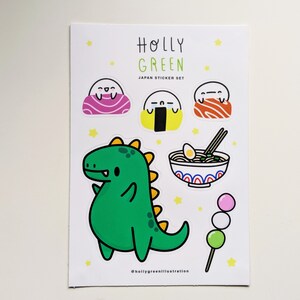 May include: A sticker sheet with a green dinosaur, a bowl of ramen, a dango, and three different types of Japanese food. The sheet is titled "Holly Green Japan Sticker Set".