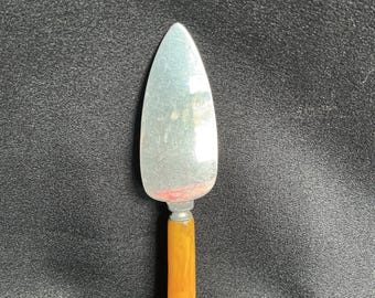 Cuchillo para queso de acero inoxidable vintage con mango de baquelita color caramelo.