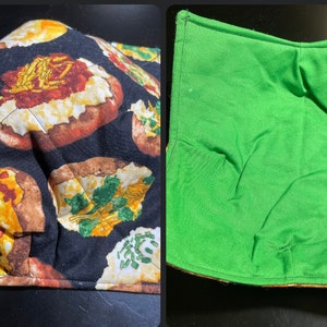 May include: Two reversible pot holders. One side is black with a repeated pattern of baked potatoes with various toppings. The other side is solid green.