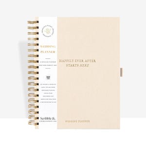 May include: A cream-colored wedding planner with gold spiral binding. The cover reads "Happily Ever After Starts Here." The planner includes sections for planning, checklists, and tips. The planner is 160 gsm.