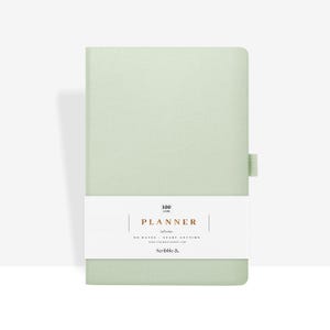 May include: A pale green planner with a white band displaying the word "PLANNER" and the text "NO DATES - START ANYTIME". The planner has a matching green elastic closure and contains 100 gsm paper.