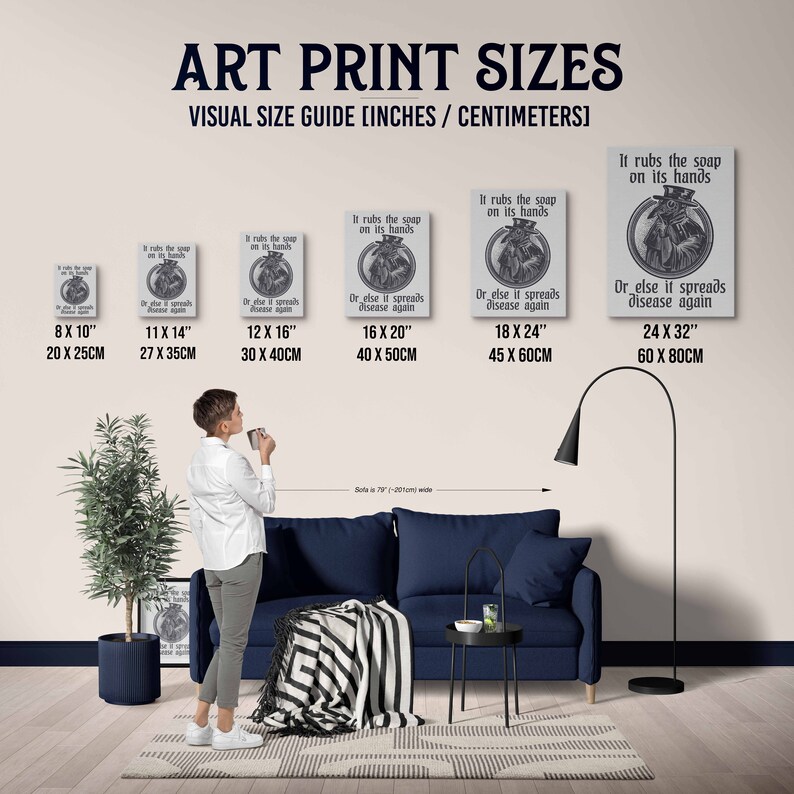 May include: A visual guide showing different art print sizes in inches and centimeters. The image shows a person standing in front of a couch and a floor lamp. The art prints feature a vintage illustration of a person wearing a mask and the text "It rubs the soap on its hands. Or else it spreads disease again."