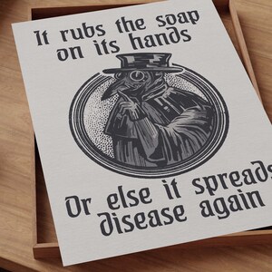May include: A black and white illustration of a plague doctor with a long beak mask and a hat. The doctor is holding a finger to their lips and the text reads "It rubs the soap on its hands Or else it spreads disease again."
