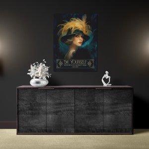 May include: A vintage-style poster with a woman wearing a black hat with feathers and a teal dress. The poster has a gold frame and the text "BE YOURSELF EVERYONE ELSE IS ALREADY TAKEN - OSCAR WILDE".