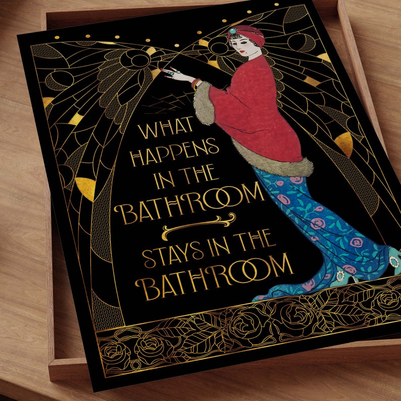 May include: A black and gold art print with a woman in a red and blue dress. The text reads "What happens in the bathroom stays in the bathroom."