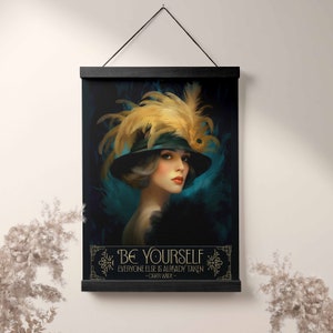 May include: A black and teal art print featuring a woman wearing a black hat with a large yellow feather. The quote "Be yourself, everyone else is already taken - Oscar Wilde" is printed below the image.