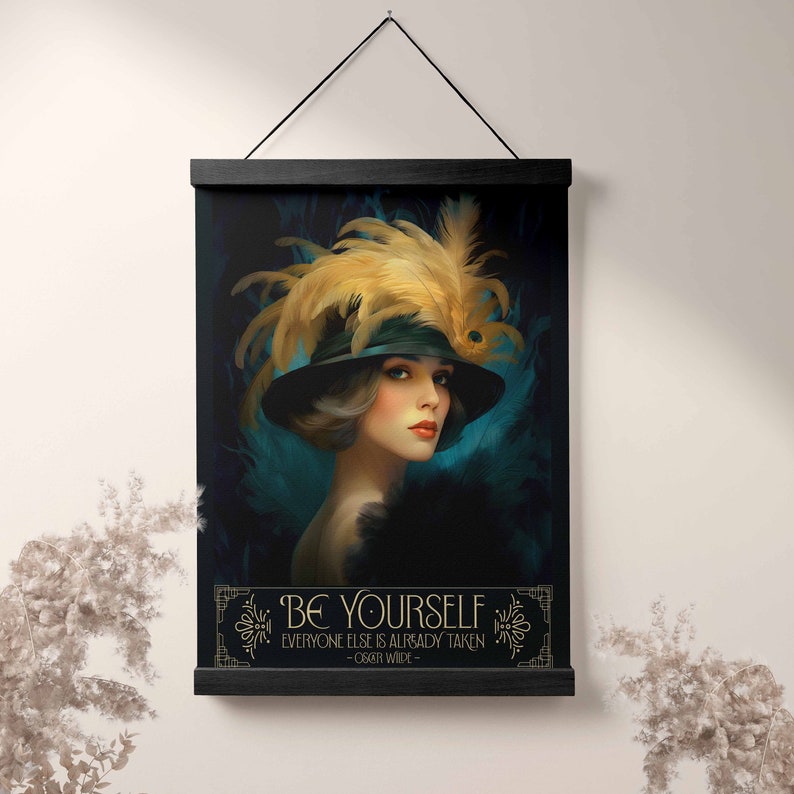 May include: A black and teal art print featuring a woman wearing a black hat with a large yellow feather. The quote "Be yourself, everyone else is already taken - Oscar Wilde" is printed below the image.