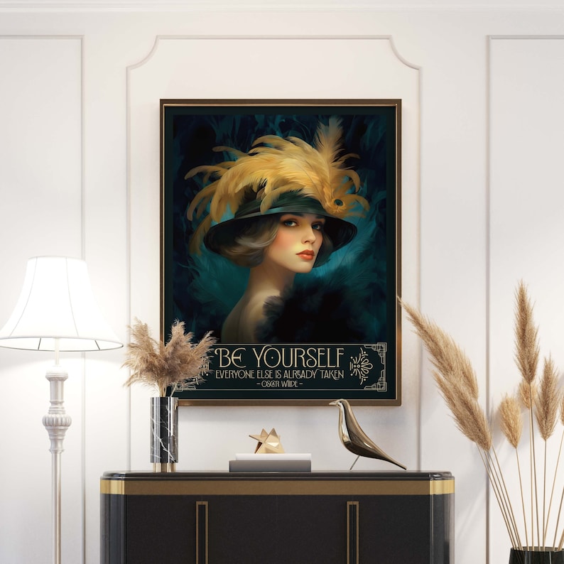 May include: A vintage-inspired art print featuring a woman wearing a large feathered hat and a quote that reads "Be Yourself, Everyone Else is Already Taken - Oscar Wilde". The background is a dark teal color with gold accents.