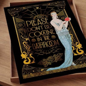 May include: Art Deco style print with a black background and gold accents. The print features a woman in a blue dress and the text "PLEASE DON'T DO COCAINE IN THE BATHROOM" in gold lettering. The print is set in a wooden tray.