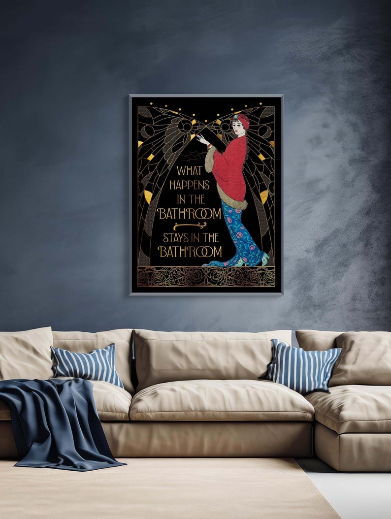 May include: A black and gold art print with a woman in a red and blue dress. The text on the print reads "What happens in the bathroom stays in the bathroom."