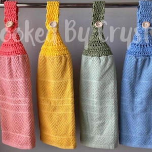 Pode incluir: Quatro toalhas de cozinha suspensas com partes superiores em croch&ecirc; nas cores coral, amarelo, verde s&aacute;lvia e azul claro. Cada toalha apresenta uma textura em espinha de peixe e um fecho de bot&atilde;o de madeira na al&ccedil;a de croch&ecirc;. O texto Hooked By Crystal &eacute; vis&iacute;vel.