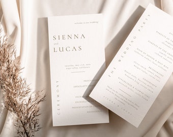 May include: A wedding invitation suite with a minimalist design. The invitation features the names "SIENNA and LUCAS" in a simple, elegant font. The wedding party details are listed on the second card, including the names of the officiant, parents of the bride and groom, maid of honor, best man, bridesmaids, groomsmen, ring bearer, and flower girl.
