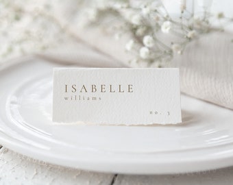 May include: White place card with the name "Isabelle Williams" and the number "3" printed in gold lettering.