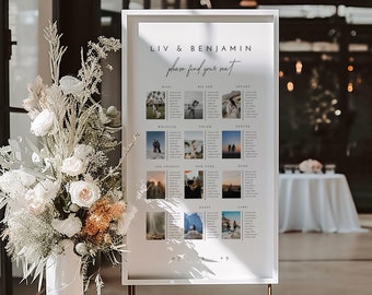 May include: A white framed wedding seating chart with the names Liv & Benjamin and the text "please find your seat". The chart features photos of the couple in different locations, with each location representing a table name. The chart is displayed on a gold metal stand.