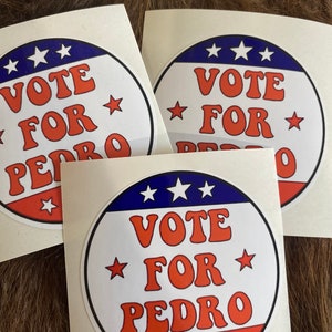May include: Three white stickers with red, white, and blue circular designs. The stickers have the text "VOTE FOR PEDRO" in a retro font.