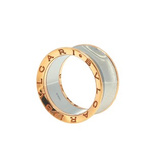 May include: A wide band ring featuring a rose gold-toned exterior with the engraved text BVLGARI on both edges. The interior of the ring is a smooth, polished silver-toned metal with the word STEEL and the number 59 engraved on the inner surface.