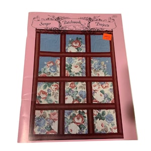 May include: A sewing pattern book titled "Serger Patchwork Projects" by Kaye Wood. The cover features a patchwork design with floral fabric squares in shades of red, blue, and white, framed by dark red borders. A pink border surrounds the design.