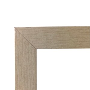May include: Close-up of the corner of a light wood picture frame. The frame is made of a smooth, light wood with a natural grain. The frame is simple and elegant, and would be a great addition to any home.