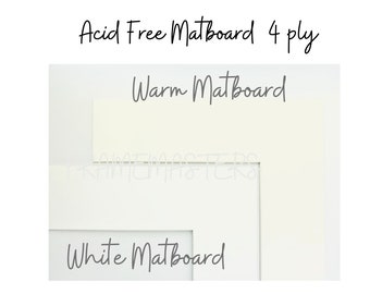 May include: Close-up of three different colors of matboard. The top matboard is labeled "Warm Matboard", the middle matboard is labeled "Frame Masters", and the bottom matboard is labeled "White Matboard".