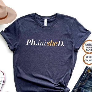 May include: A navy blue t-shirt with the text "Ph.inished." in white and yellow lettering. The shirt is available in unisex and plus sizes and in multiple colors.
