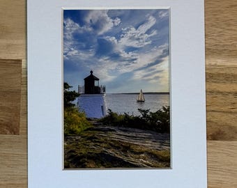Photo of Castle Hill Lighthouse with a passing Sailboat in Newport, RI