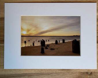 Photo of Old Pier Posts in the Sand and Ocean in East Providence Rhode Island