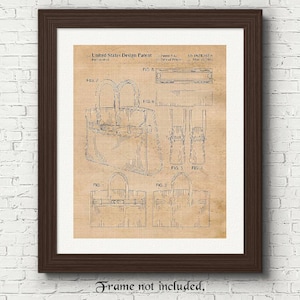May include: A framed print featuring a vintage design patent for a handbag. The patent details are displayed in black ink on a tan background, with various diagrams and labels. The frame is dark brown, and the text "Frame not included" is at the bottom.