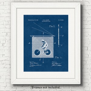 May include: A vintage blueprint style illustration of a patent for an advertising sign featuring a cyclist riding a bicycle. The patent is dated April 28, 1886 and is titled "F.B. Hart Advertising Sign". The patent number is 25,448.