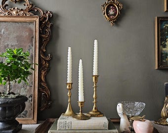 Curated collection of 3 brass candlesticks
