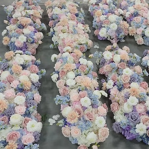 May include: A collection of floral arrangements featuring a mix of pink, white, and blue flowers. The arrangements are made up of roses, hydrangeas, and other blooms.