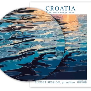 May include: A digital illustration of a sunset reflected in the water. The water is a deep blue with white lines representing ripples. The text "CROATIA" is at the top of the image, and the text "Tiha voda brege dere." is below it. The text "SUNSET SESSION, primo&scaron;ten" is at the bottom of the image, along with the text "AUGUST, 2021" and "CINDY TIMMER."