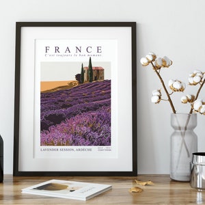 May include: A vintage travel poster featuring a purple lavender field with a small house and trees in the background. The text on the poster reads "FRANCE C'est toujours le bon moment. LAVENDER SESSION, ARD&Egrave;CHE JULY 1971 CROIX TYMBER"