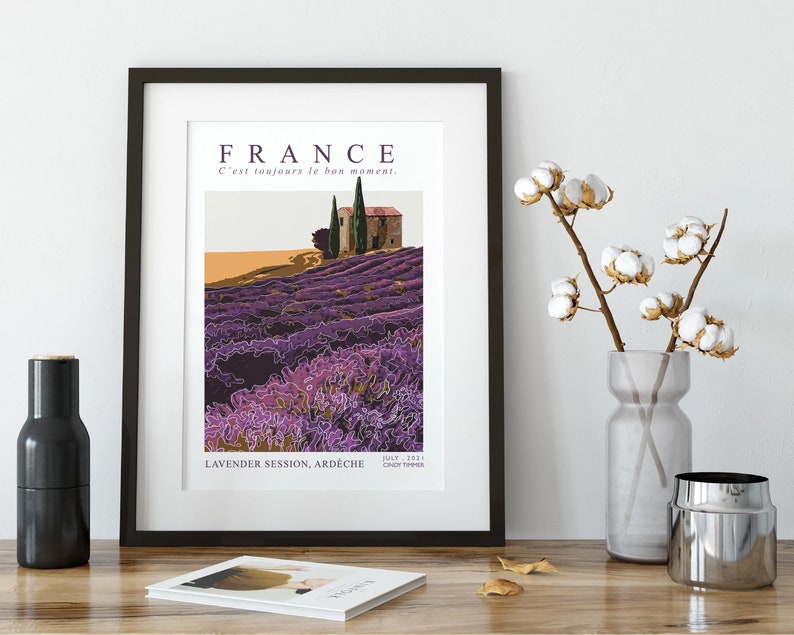 May include: A vintage travel poster featuring a purple lavender field with a small house and trees in the background. The text on the poster reads "FRANCE C'est toujours le bon moment. LAVENDER SESSION, ARD&Egrave;CHE JULY 1971 CROIX TYMBER"