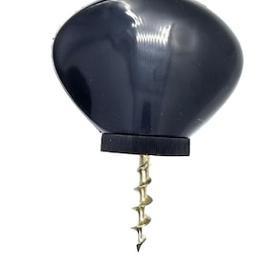 May include: A black rubber bottle stopper with a silver corkscrew. The stopper is shaped like a teardrop and has a black plastic ring around the top.