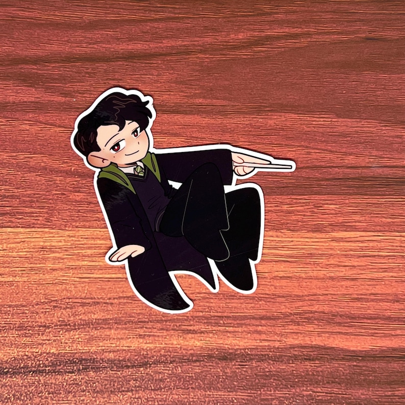 May include: A cartoon illustration of a person wearing a black and green robe with a wand in their hand. The person is in a flying pose.