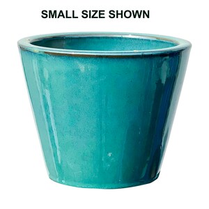 May include: A turquoise ceramic planter with a glossy finish. The planter has a slightly flared, trapezoidal shape and a rounded rim. The text "SMALL SIZE SHOWN" is at the top of the image.