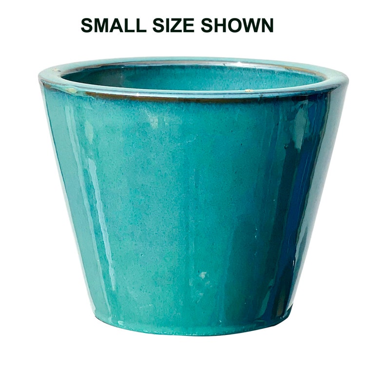 May include: A turquoise ceramic planter with a glossy finish. The planter has a slightly flared, trapezoidal shape and a rounded rim. The text "SMALL SIZE SHOWN" is at the top of the image.