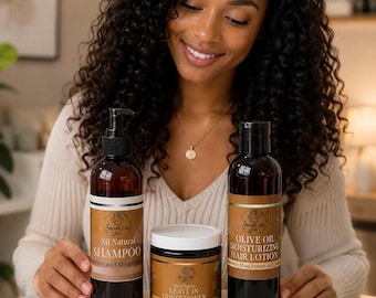 May include: A set of three hair care products in brown bottles and a jar, labeled Smooth Like Jas. The collection includes All Natural Shampoo, Shea Butter Leave In Conditioner, and Olive Oil Moisturizing Hair Lotion, all presented in a branded box.