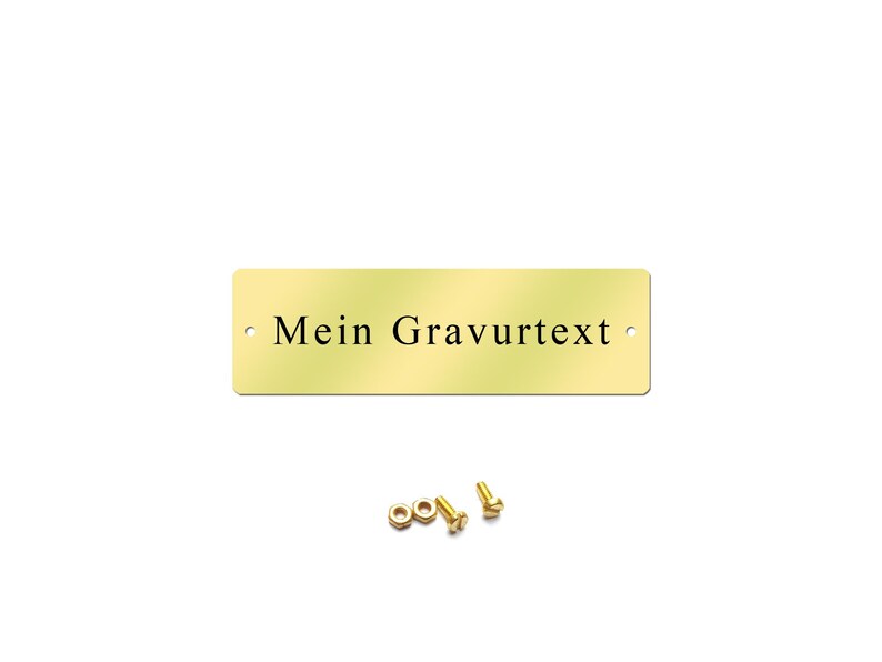 May include: A gold-colored metal plaque with rounded corners and two holes. The plaque has the text "Mein Gravurtext" engraved on it.