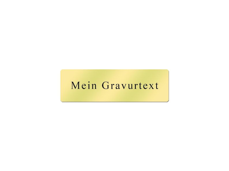 May include: A gold-colored rectangular nameplate with the text "Mein Gravurtext" in black.