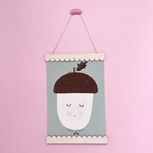 May include: A light green poster with a brown and white acorn illustration. The acorn has a smiling face and the text "ACORN SMALL & MIGHTY" is printed below it.