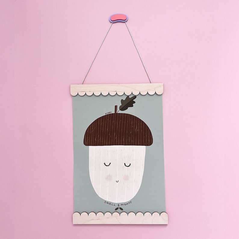 May include: A light green poster with a brown and white acorn illustration. The acorn has a smiling face and the text "ACORN SMALL & MIGHTY" is printed below it.